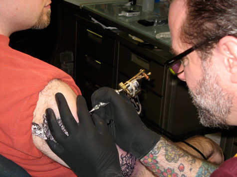 Mike tattooing Josh.